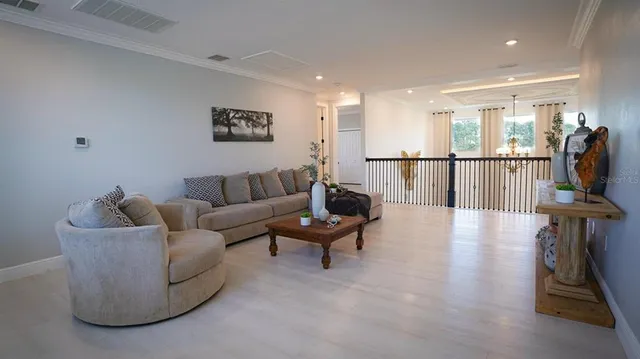 a utility room with wooden floor washer and dryer