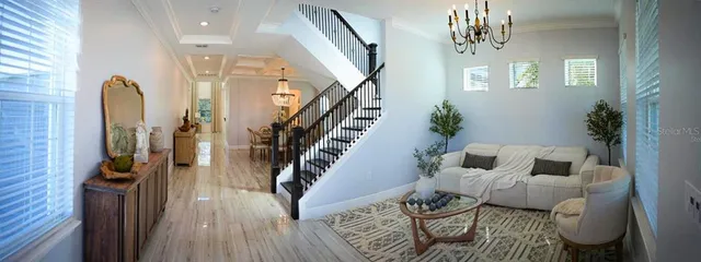 a living room with furniture and a chandelier