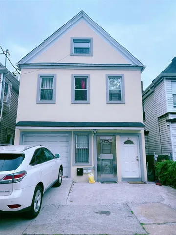 a front view of a house with parking space