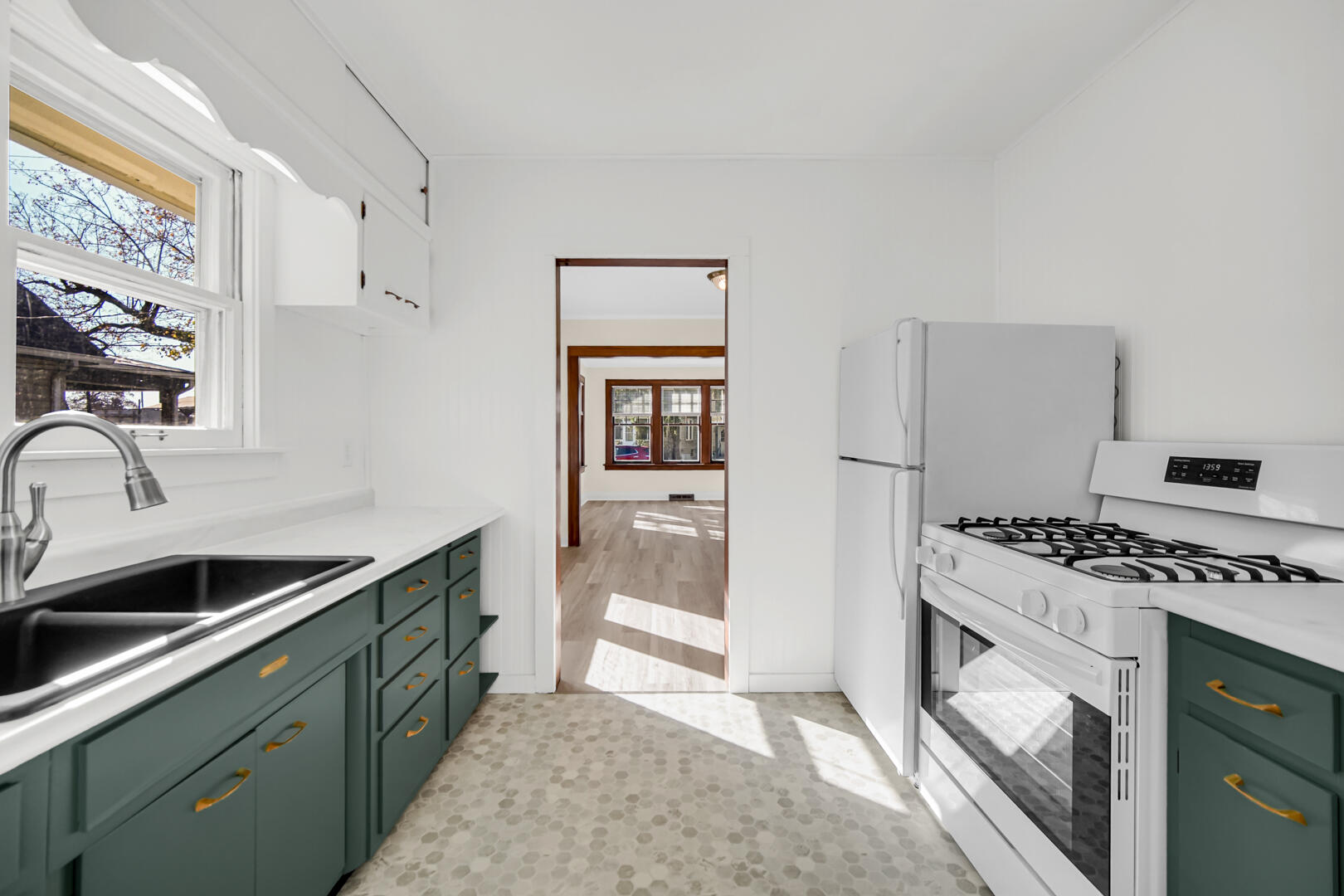 609 Main Street Hobart, IN 46342 - Photo 12 of 18 a kitchen with stainless steel appliances granite countertop a stove and a sink