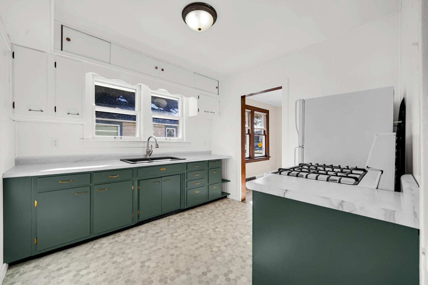 609 Main Street Hobart, IN 46342 - Photo 13 of 18 a kitchen with a sink stove and refrigerator