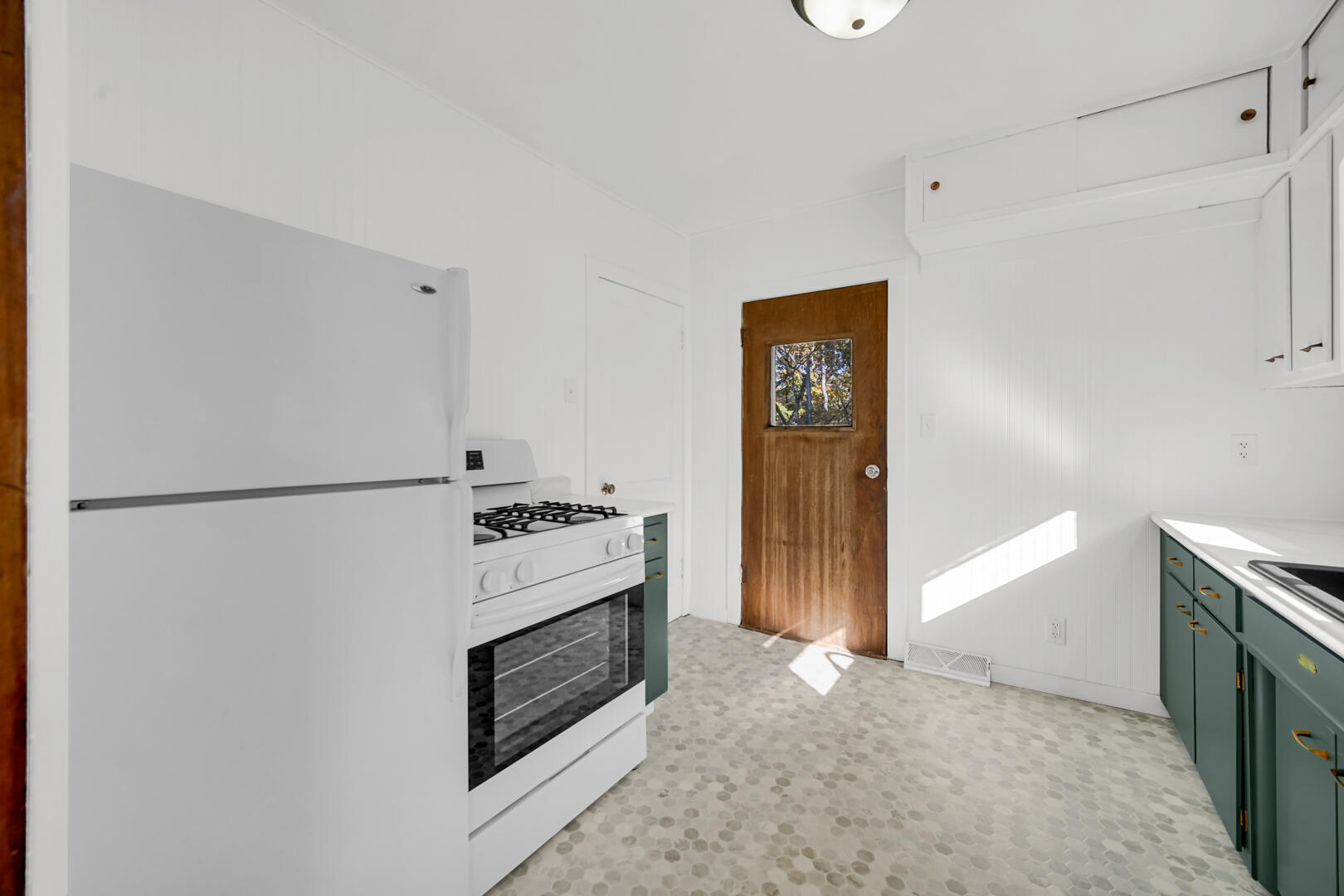 609 Main Street Hobart, IN 46342 - Photo 15 of 18 a kitchen with a stove and a refrigerator