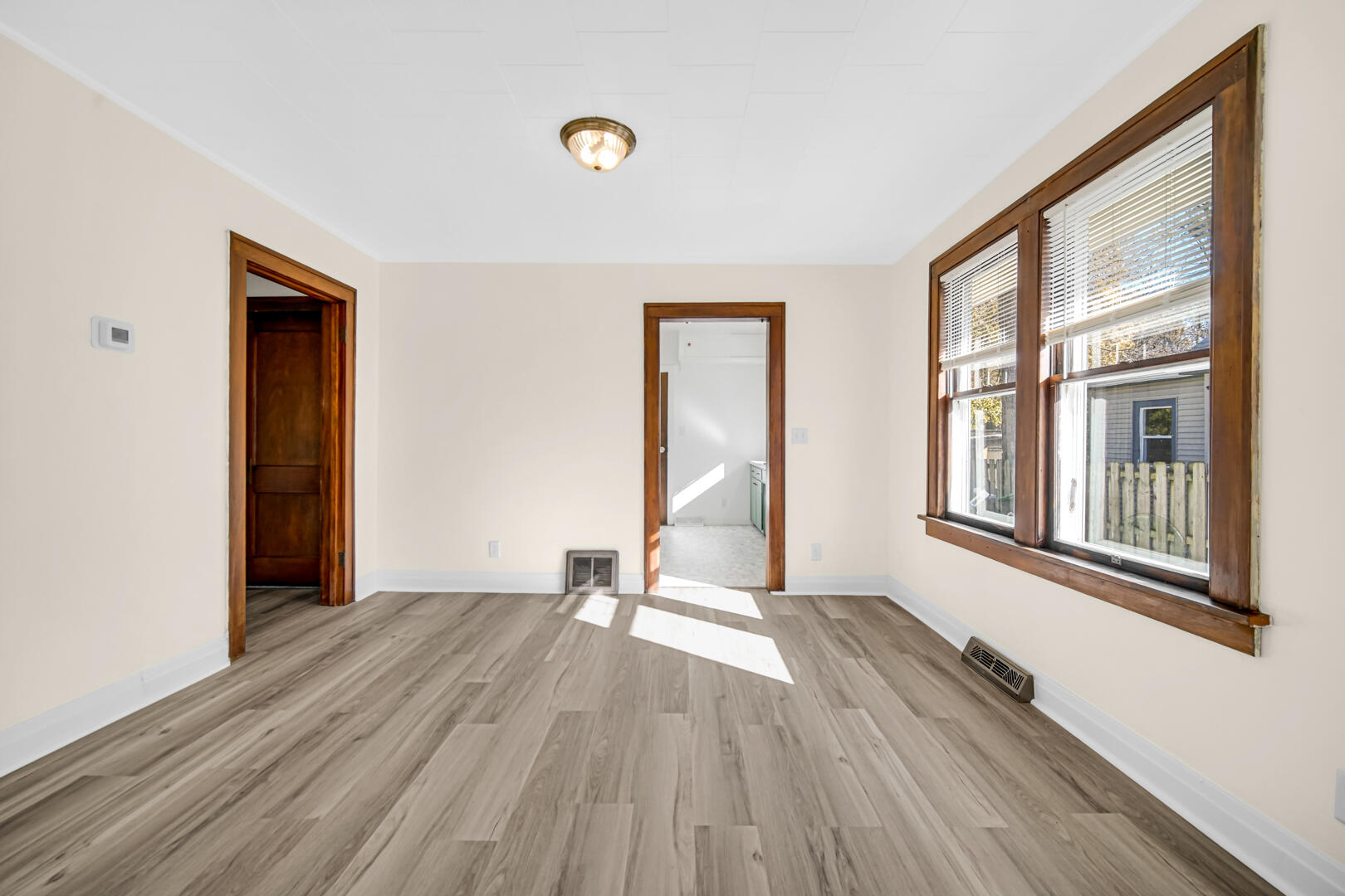 609 Main Street Hobart, IN 46342 - Photo 5 of 18 a view of an empty room with wooden floor and a window