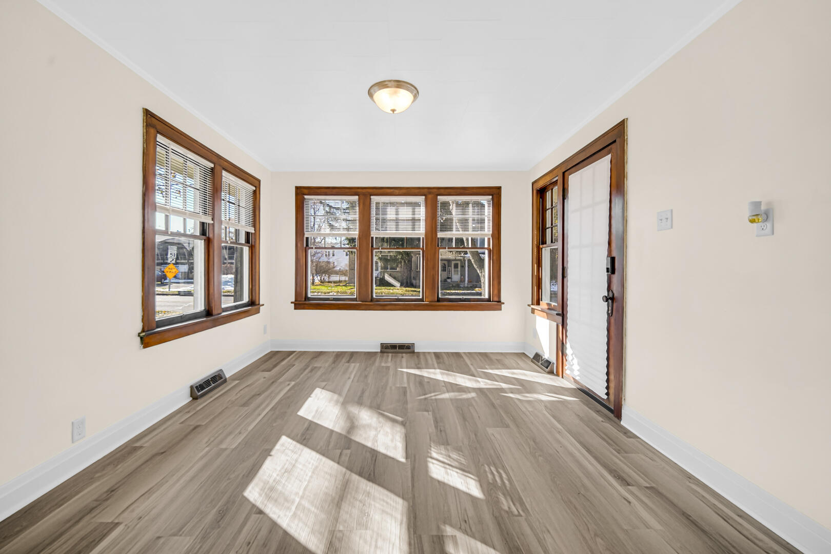 609 Main Street Hobart, IN 46342 - Photo 6 of 18 a view of an empty room with a window and wooden floor