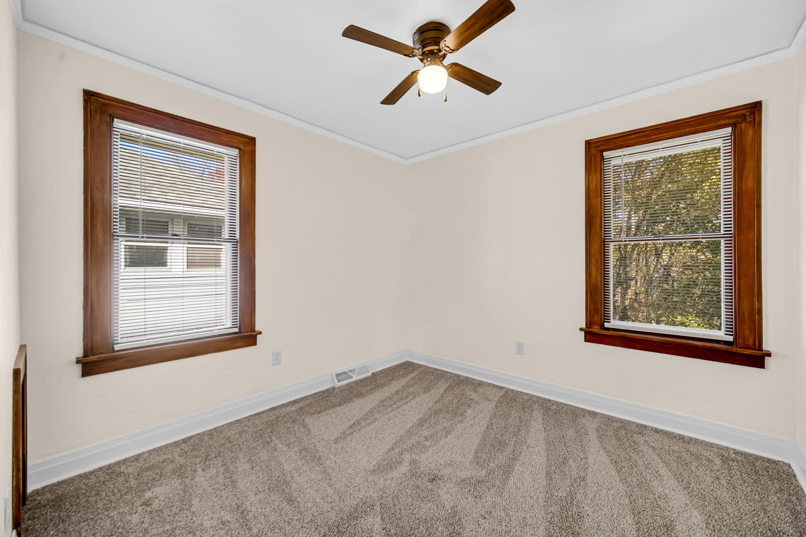 609 Main Street Hobart, IN 46342 - Photo 9 of 18 an empty room with a window and a ceiling fan