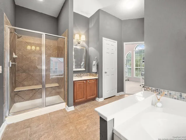 a spacious bathroom with a shower and a sink