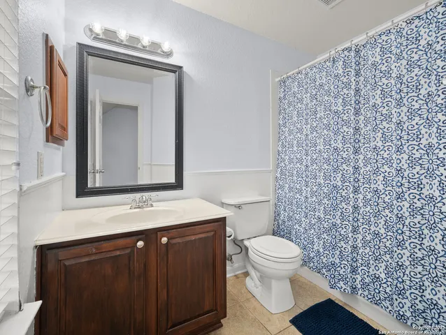 a bathroom with a toilet a sink and a mirror