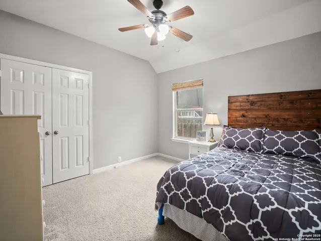 a bedroom with a large bed and a window