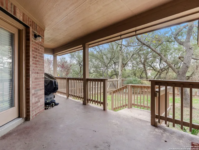 a view of a porch with furniture and floor to ceiling window