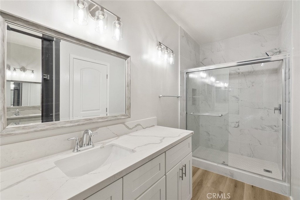 2504 West MacArthur Boulevard Santa Ana, CA 92704 - Photo 11 of 19 a bathroom with a shower sink and mirror