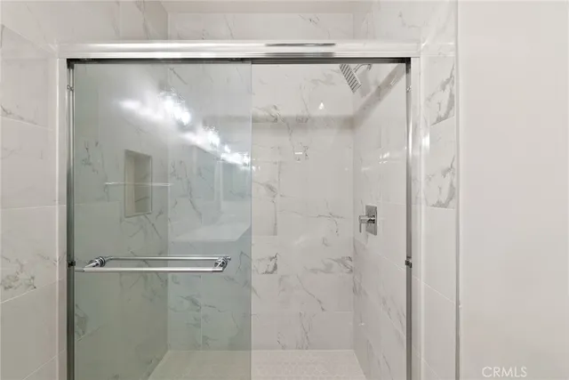 a bathroom with a glass shower door
