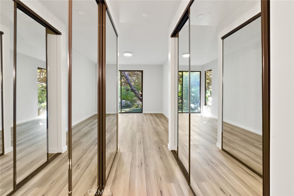 2504 West MacArthur Boulevard Santa Ana, CA 92704 - Photo 13 of 19 a view of a hallway with wooden floor and staircase