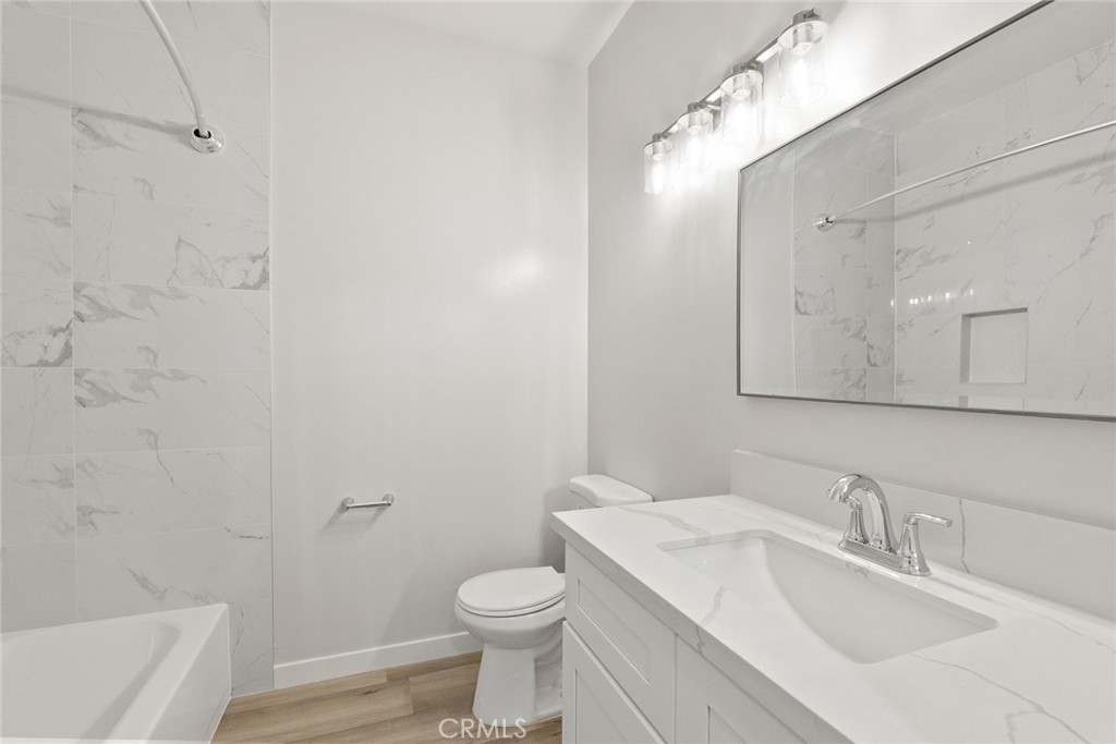 2504 West MacArthur Boulevard Santa Ana, CA 92704 - Photo 14 of 19 a bathroom with a sink toilet and shower