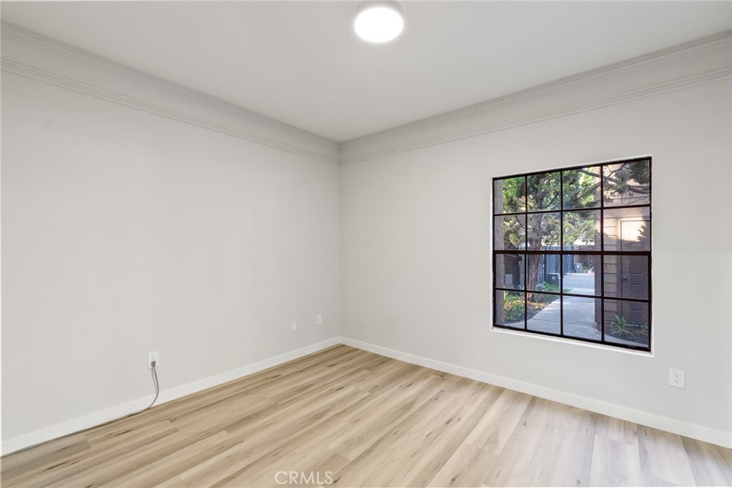 2504 West MacArthur Boulevard Santa Ana, CA 92704 - Photo 15 of 19 wooden floor in an empty room with a window