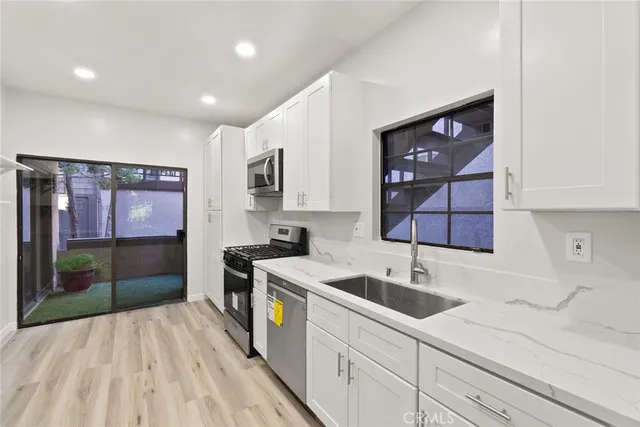 a kitchen with a sink and cabinets