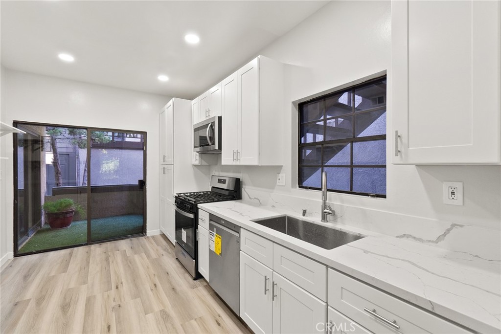 2504 West MacArthur Boulevard Santa Ana, CA 92704 - Photo 4 of 19 a kitchen with a sink and cabinets