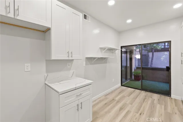 a kitchen with a sink cabinets and appliances