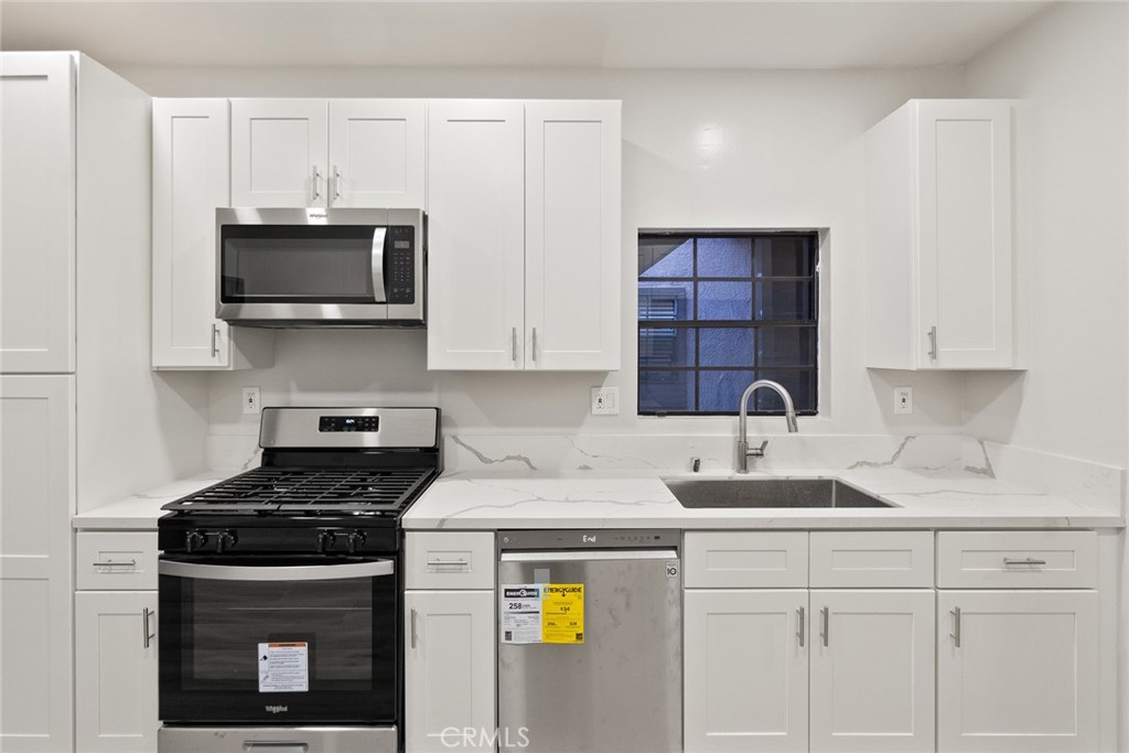 2504 West MacArthur Boulevard Santa Ana, CA 92704 - Photo 8 of 19 a kitchen with stainless steel appliances granite countertop a sink stove and microwave