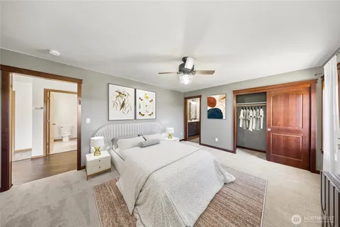 a spacious bedroom with a large bed and a chandelier