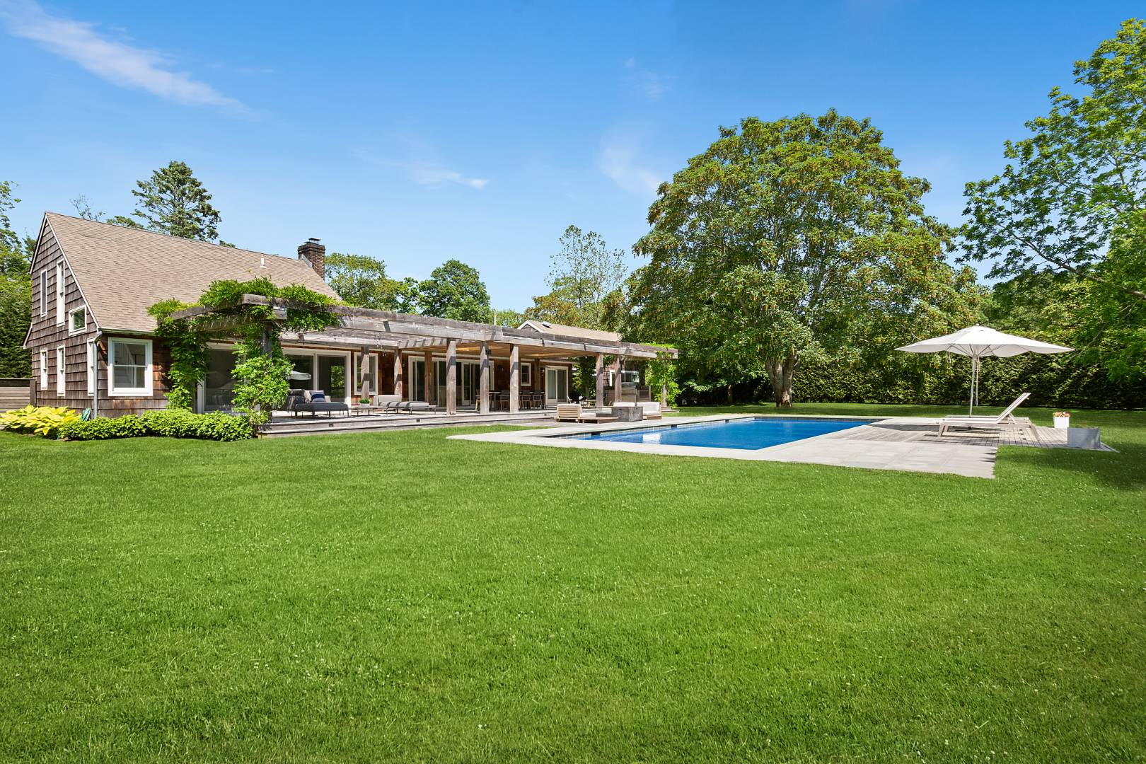 4 Jericho Close Lane East Hampton, NY 11937 - Photo 18 of 26 a view of a house with a swimming pool and a yard