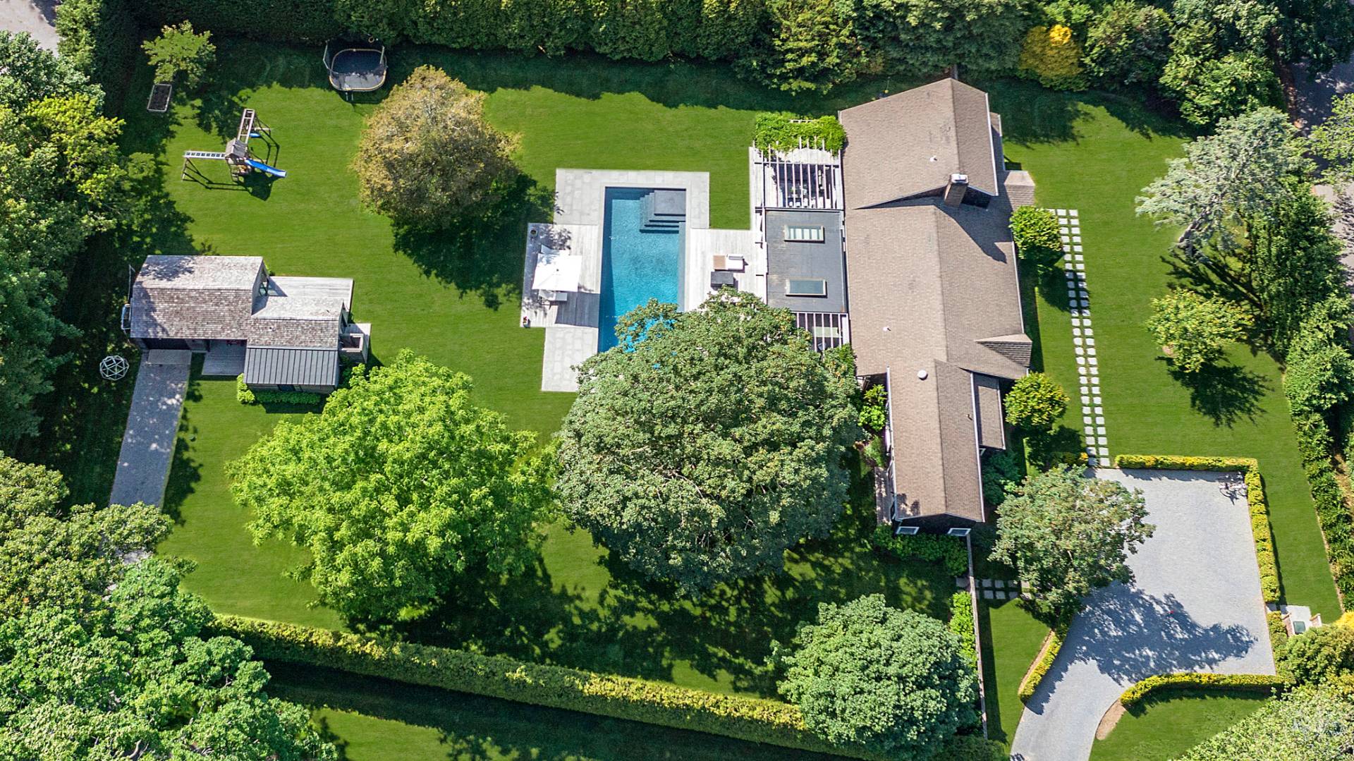 4 Jericho Close Lane East Hampton, NY 11937 - Photo 24 of 26 an aerial view of a house with a yard lake and trees all around