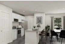 a kitchen with stainless steel appliances kitchen island granite countertop a refrigerator and a stove top oven