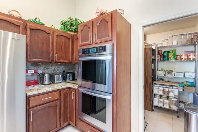 a living room with furniture a chandelier and a potted plant