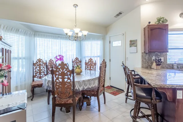 a living room with furniture and a kitchen view
