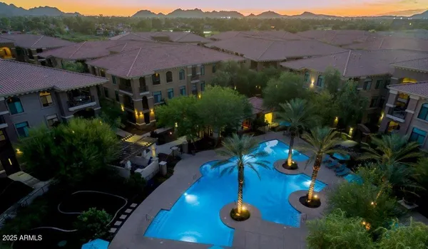 an aerial view of house yard and mountain view in back