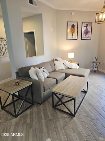 a living room with furniture and a wooden floor
