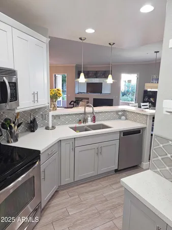a kitchen with a sink stove and cabinets