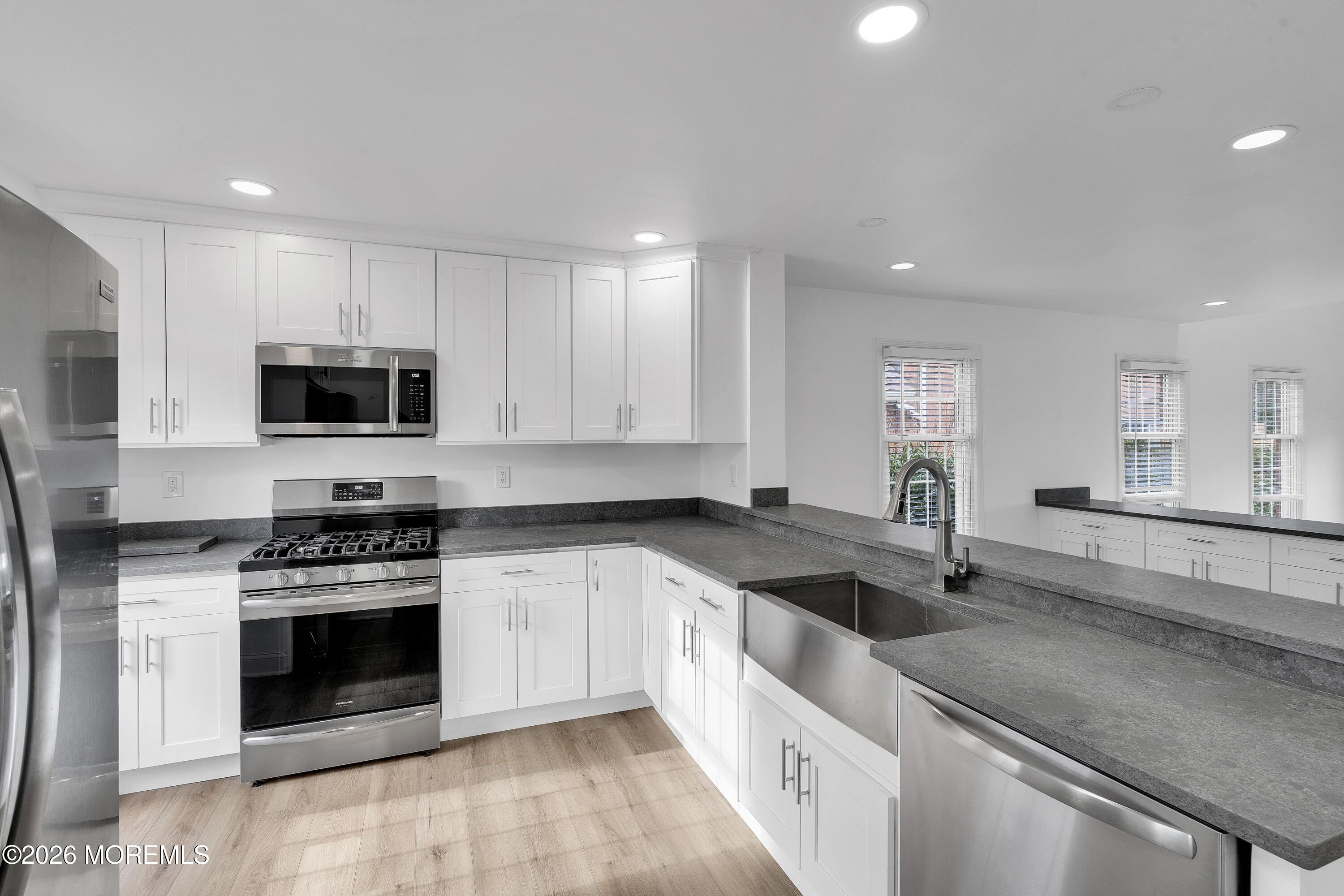 15 Wyckham Road Spring Lake Heights, NJ 07762 - Photo 11 of 38 a kitchen with granite countertop a stove sink and microwave