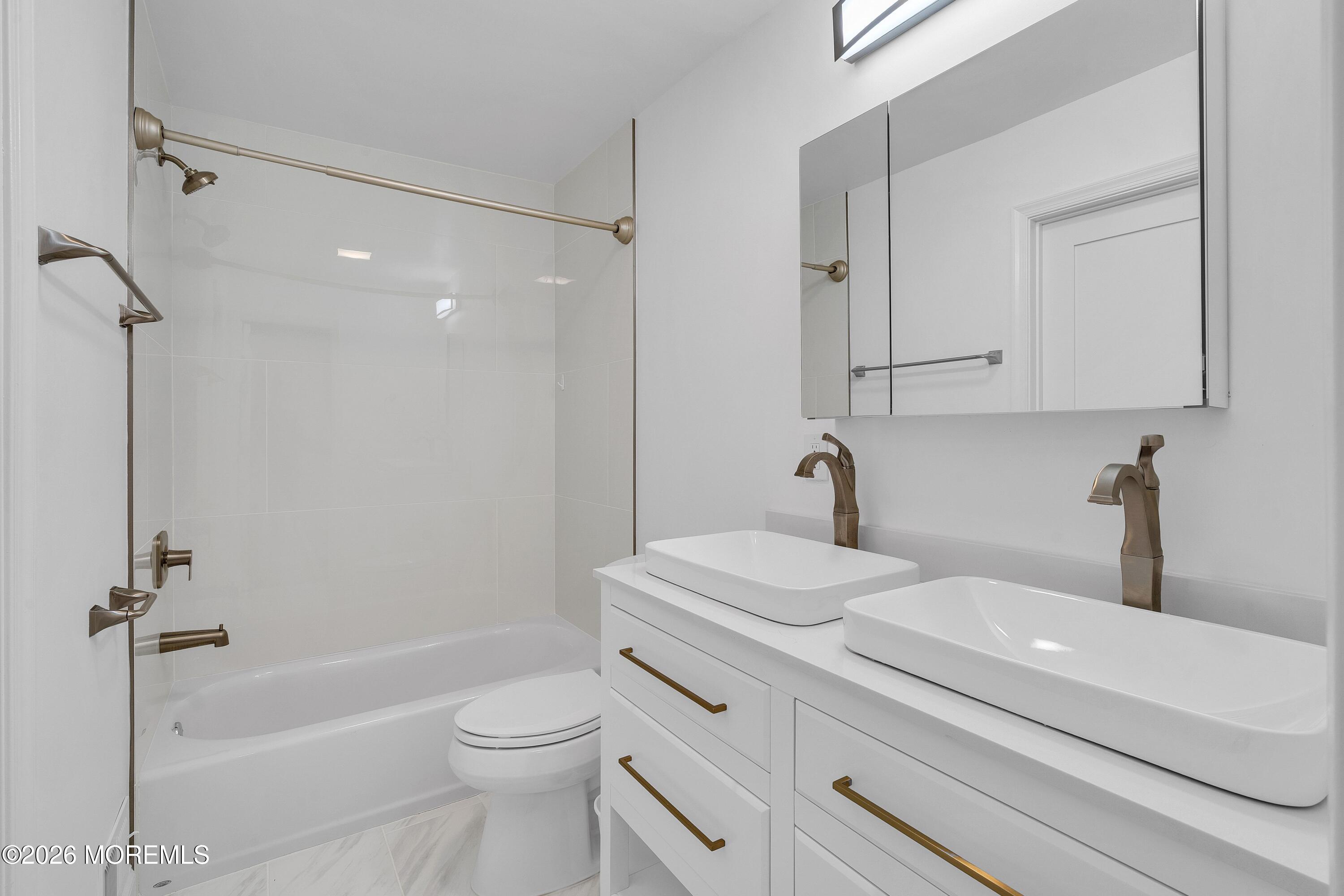 15 Wyckham Road Spring Lake Heights, NJ 07762 - Photo 16 of 38 a bathroom with a sink a toilet and a bathtub