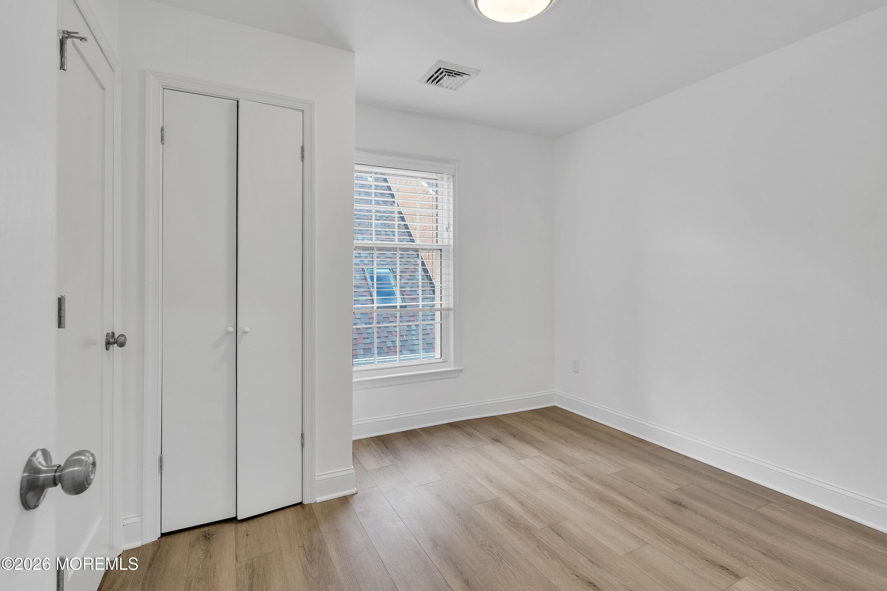 15 Wyckham Road Spring Lake Heights, NJ 07762 - Photo 17 of 38 an empty room with wooden floor and windows