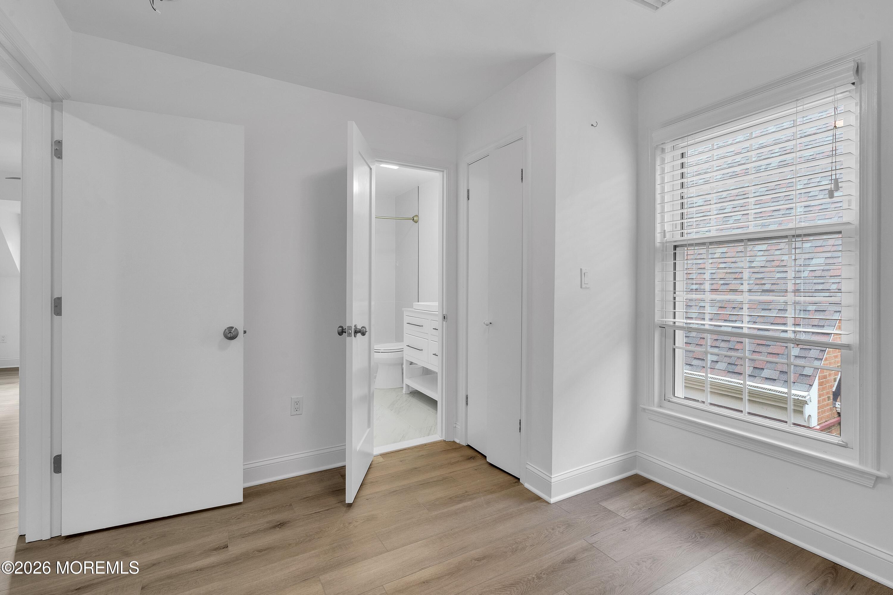 15 Wyckham Road Spring Lake Heights, NJ 07762 - Photo 18 of 38 a view of an empty room with wooden floor and a window