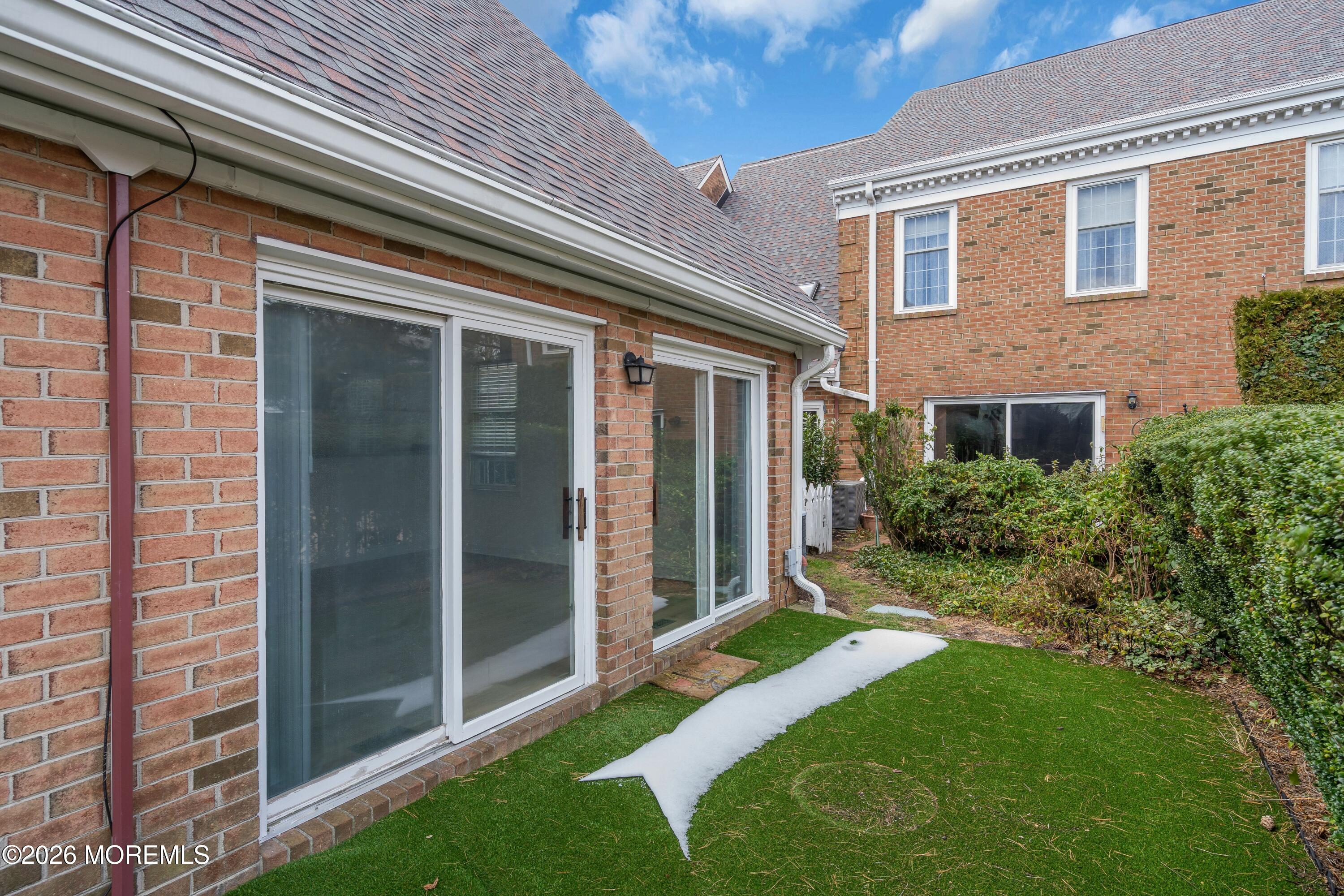 15 Wyckham Road Spring Lake Heights, NJ 07762 - Photo 30 of 38 a view of backyard with large windows and plants