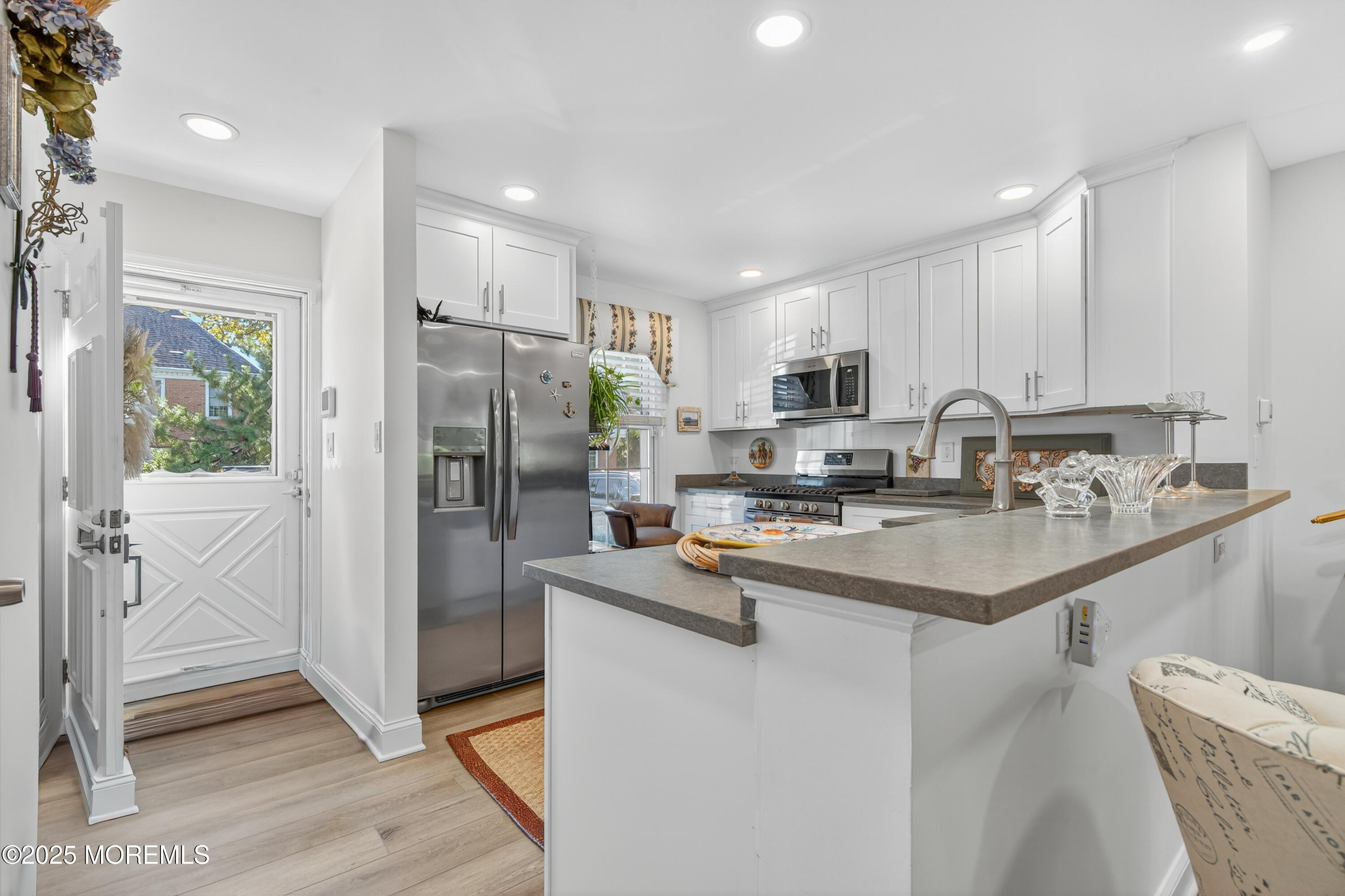 15 A Wyckham Road Spring Lake Heights, NJ 07762 - Photo 3 of 12 a kitchen with stainless steel appliances granite countertop a refrigerator a sink a stove a microwave and island