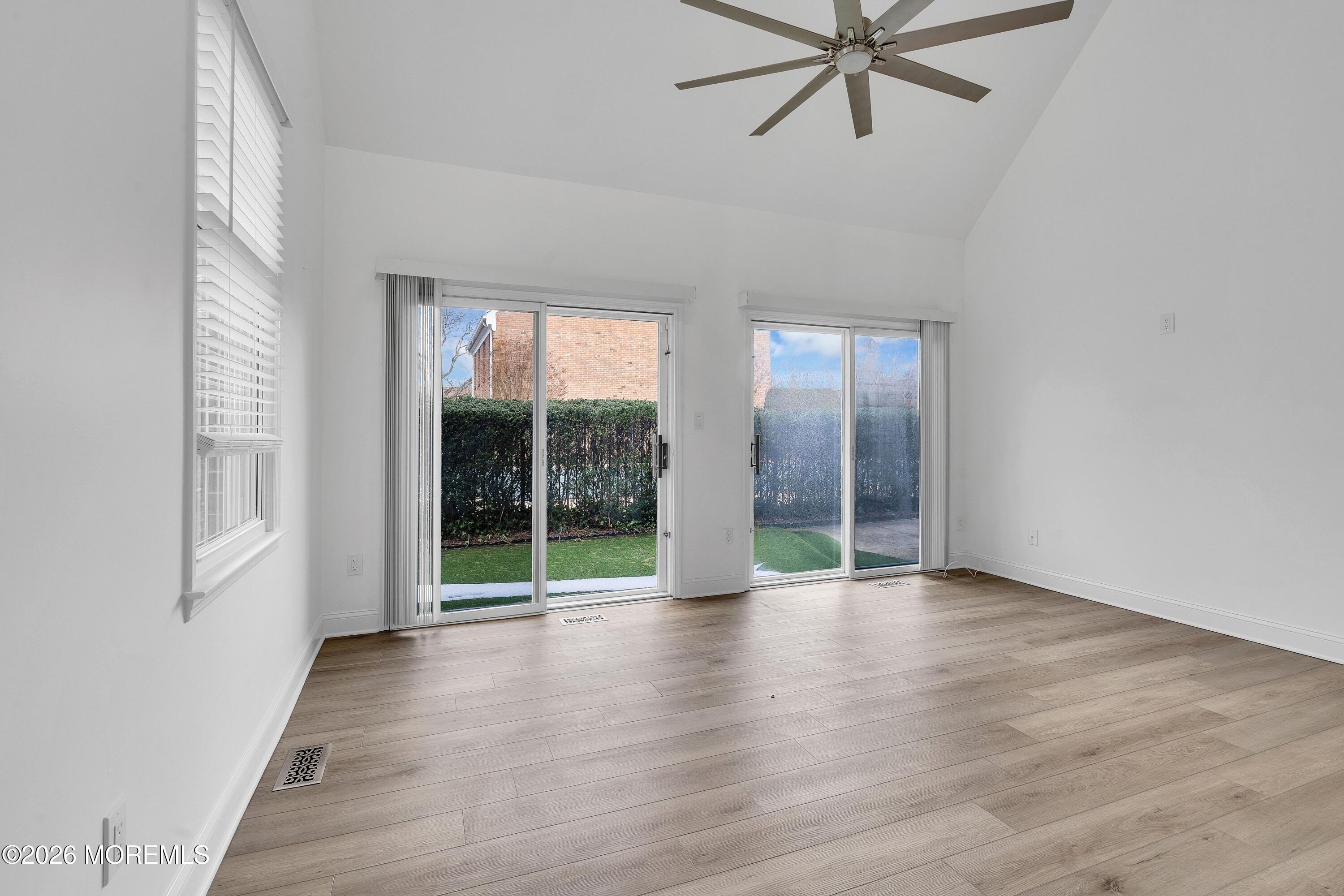 15 Wyckham Road Spring Lake Heights, NJ 07762 - Photo 6 of 38 an empty room with wooden floor and windows