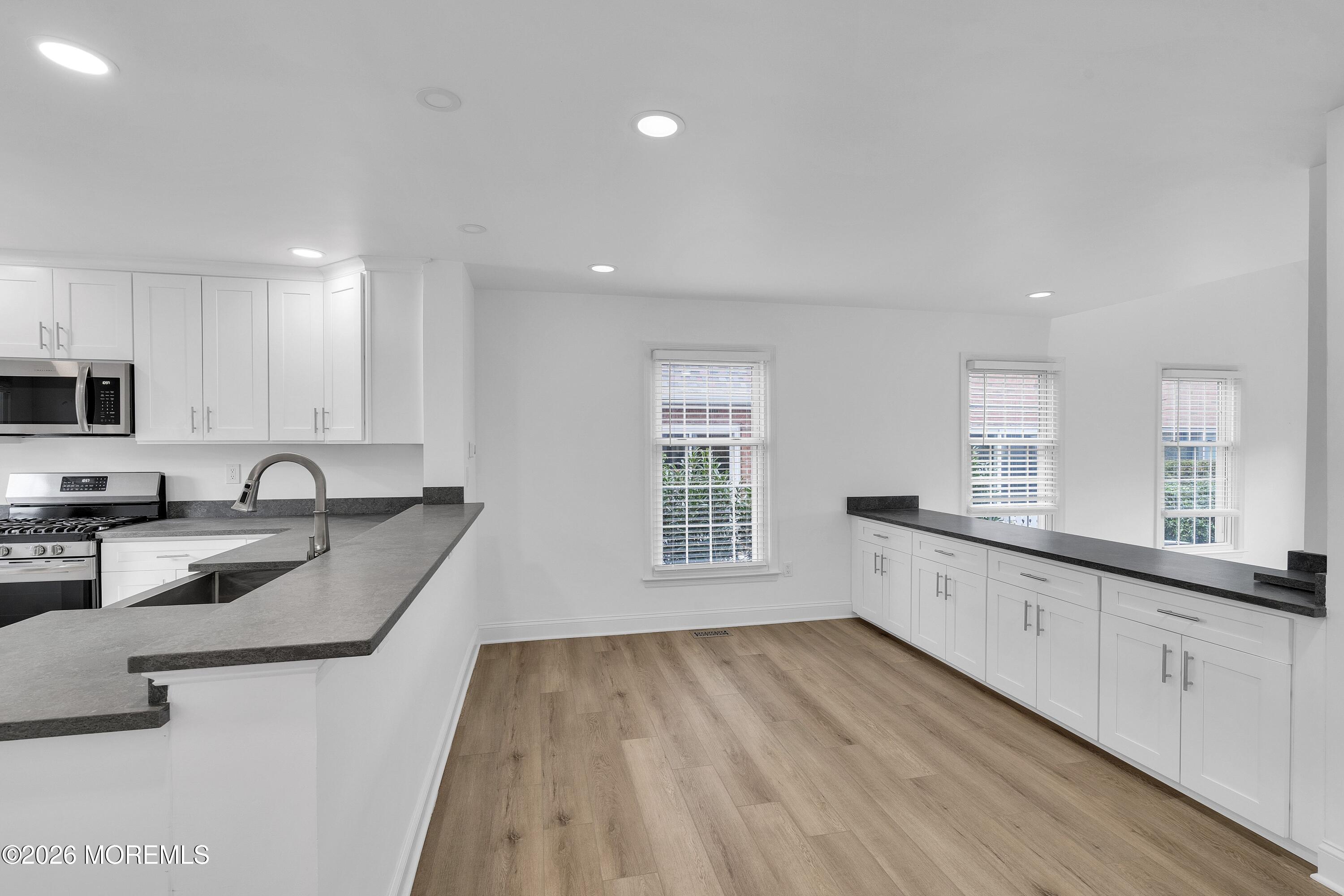 15 Wyckham Road Spring Lake Heights, NJ 07762 - Photo 7 of 38 a large kitchen with granite countertop a sink a counter space appliances and cabinets