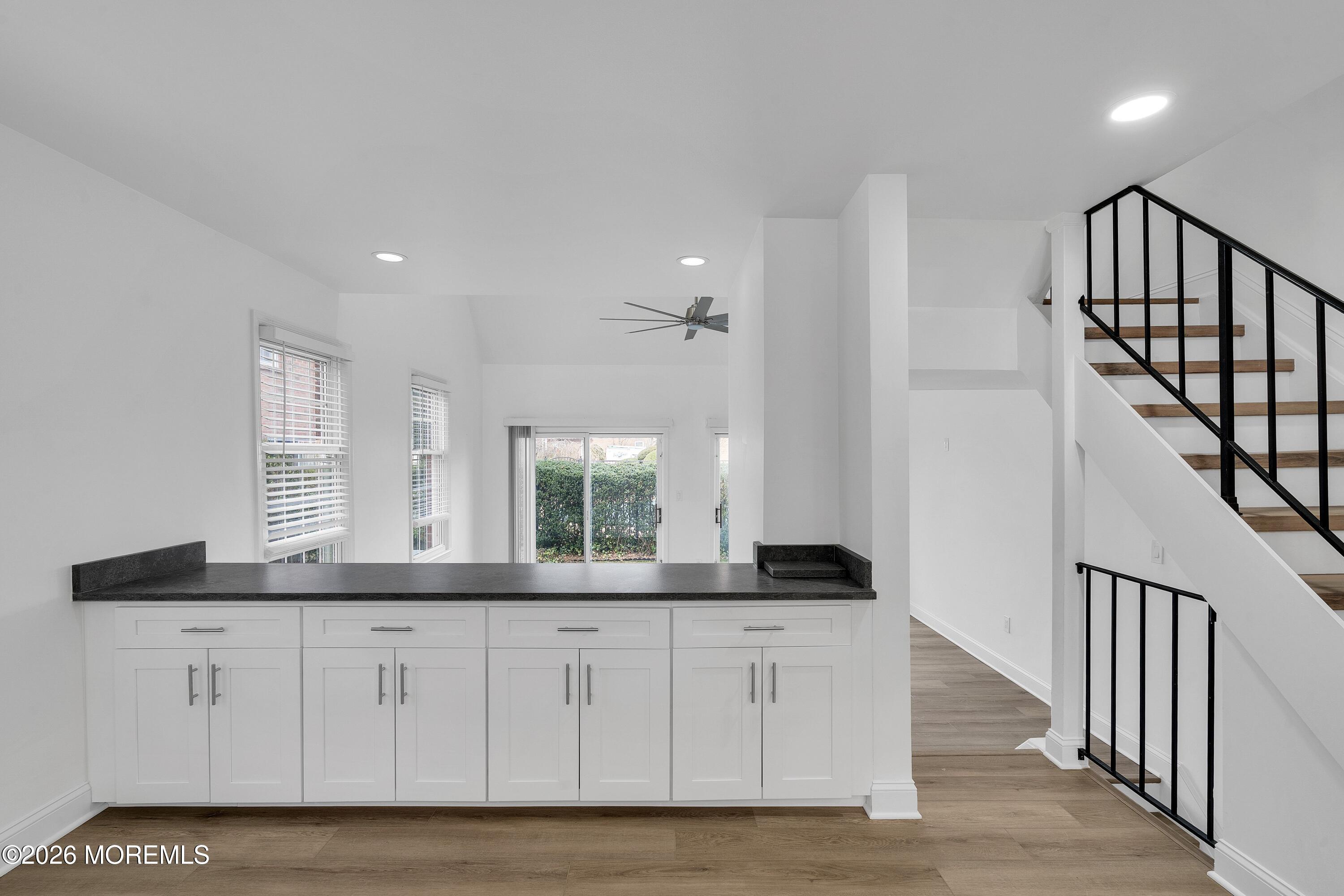 15 Wyckham Road Spring Lake Heights, NJ 07762 - Photo 9 of 38 a hallway with white cabinets and chandelier