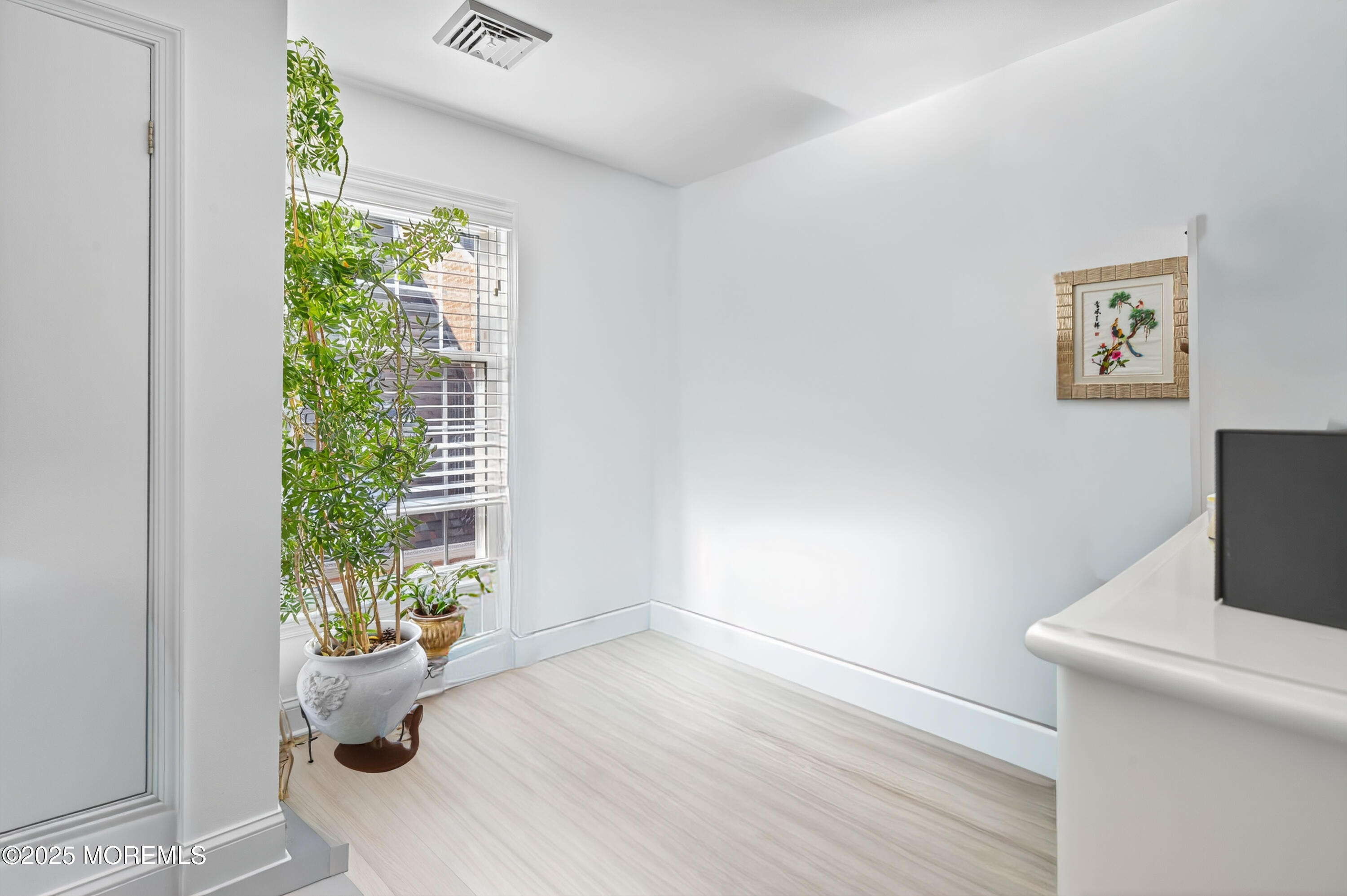 15 A Wyckham Road Spring Lake Heights, NJ 07762 - Photo 10 of 12 a view of a room that has a window and a potted plant