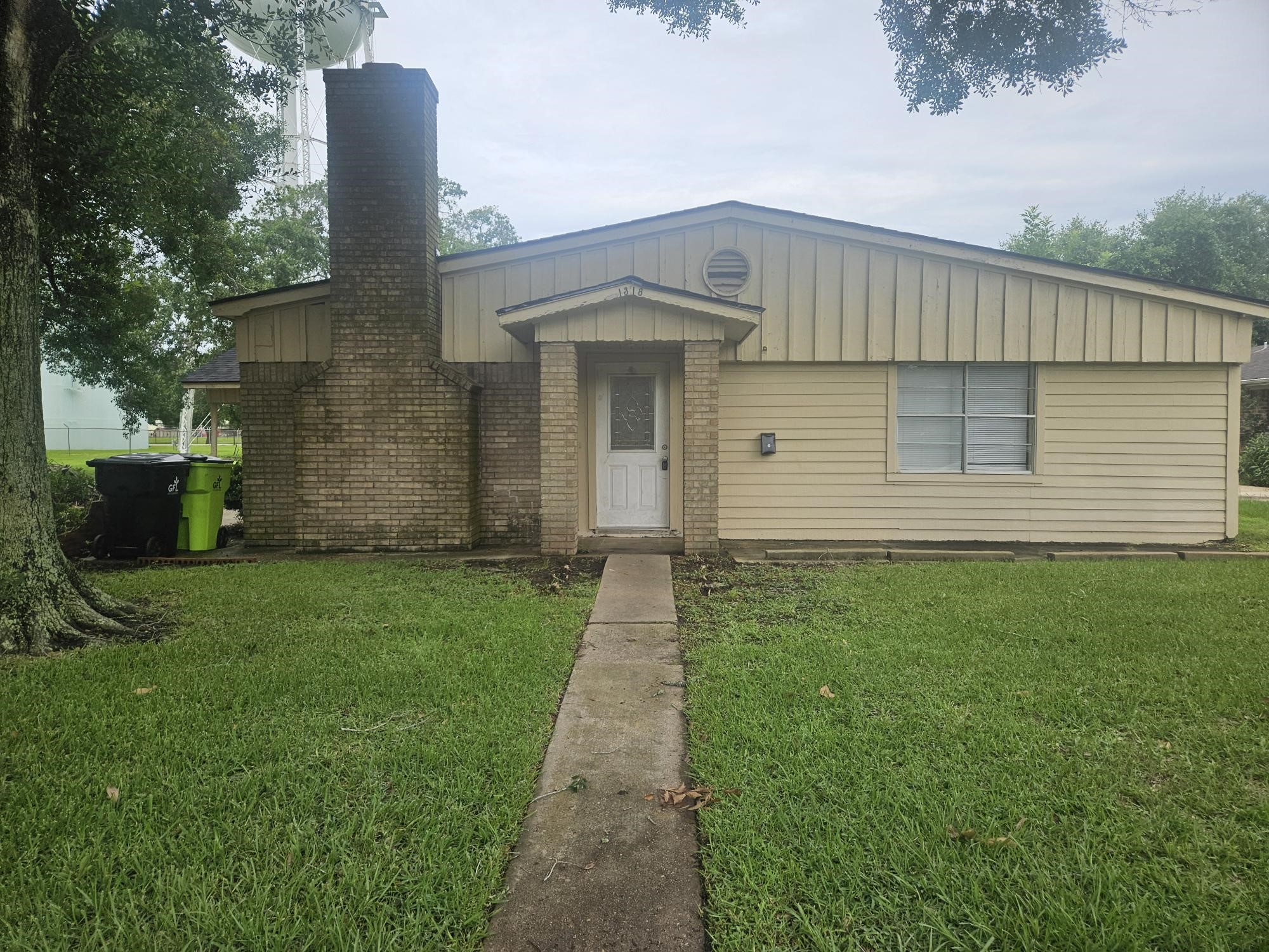 1318-1 Austin Street Rosenberg, TX 77471 - Photo 1 of 5 a front view of a house with a garden