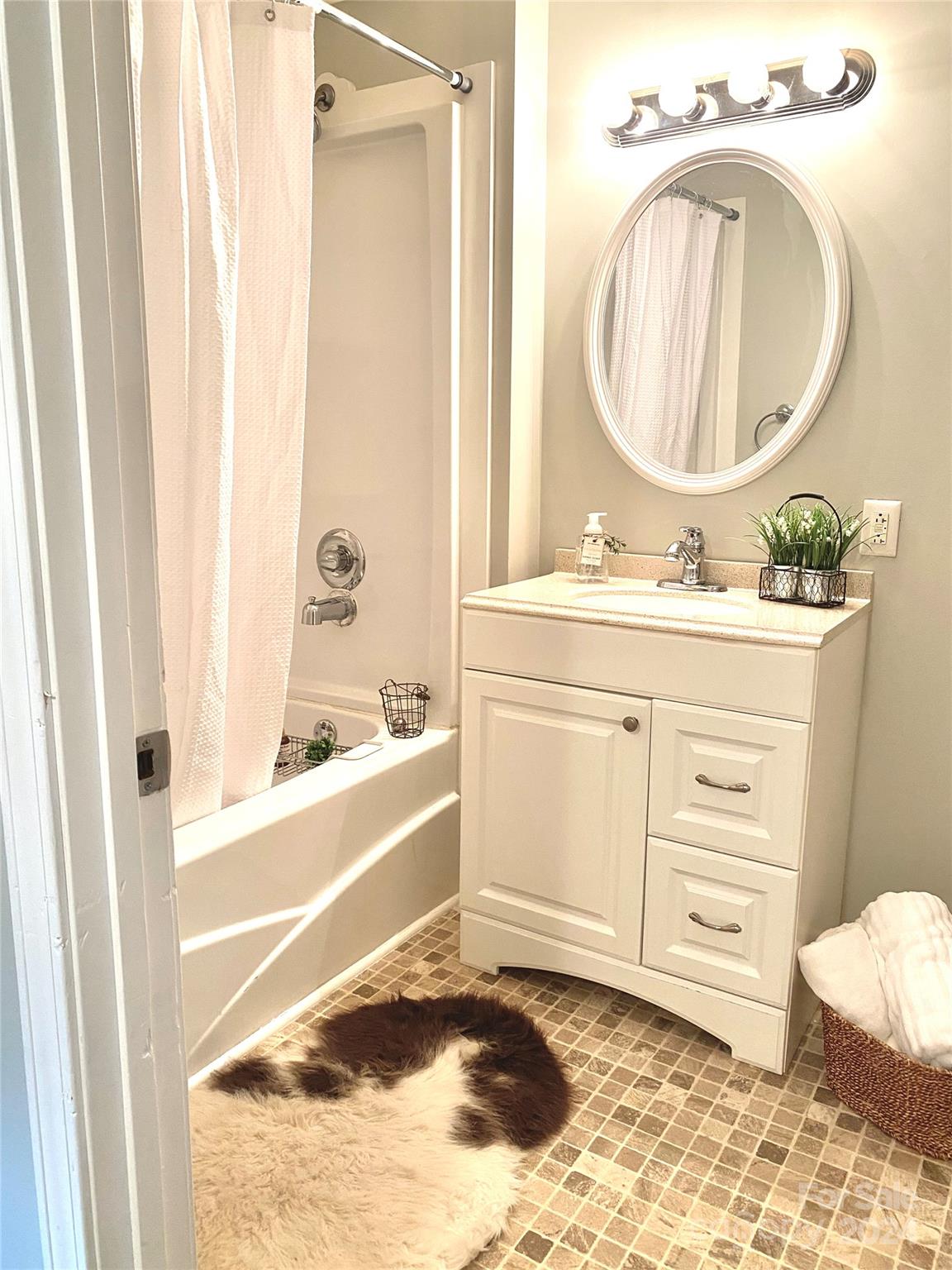 417 East Rice Street Landis, NC 28088 - Photo 19 of 22 a bathroom with a sink a mirror and a bathtub
