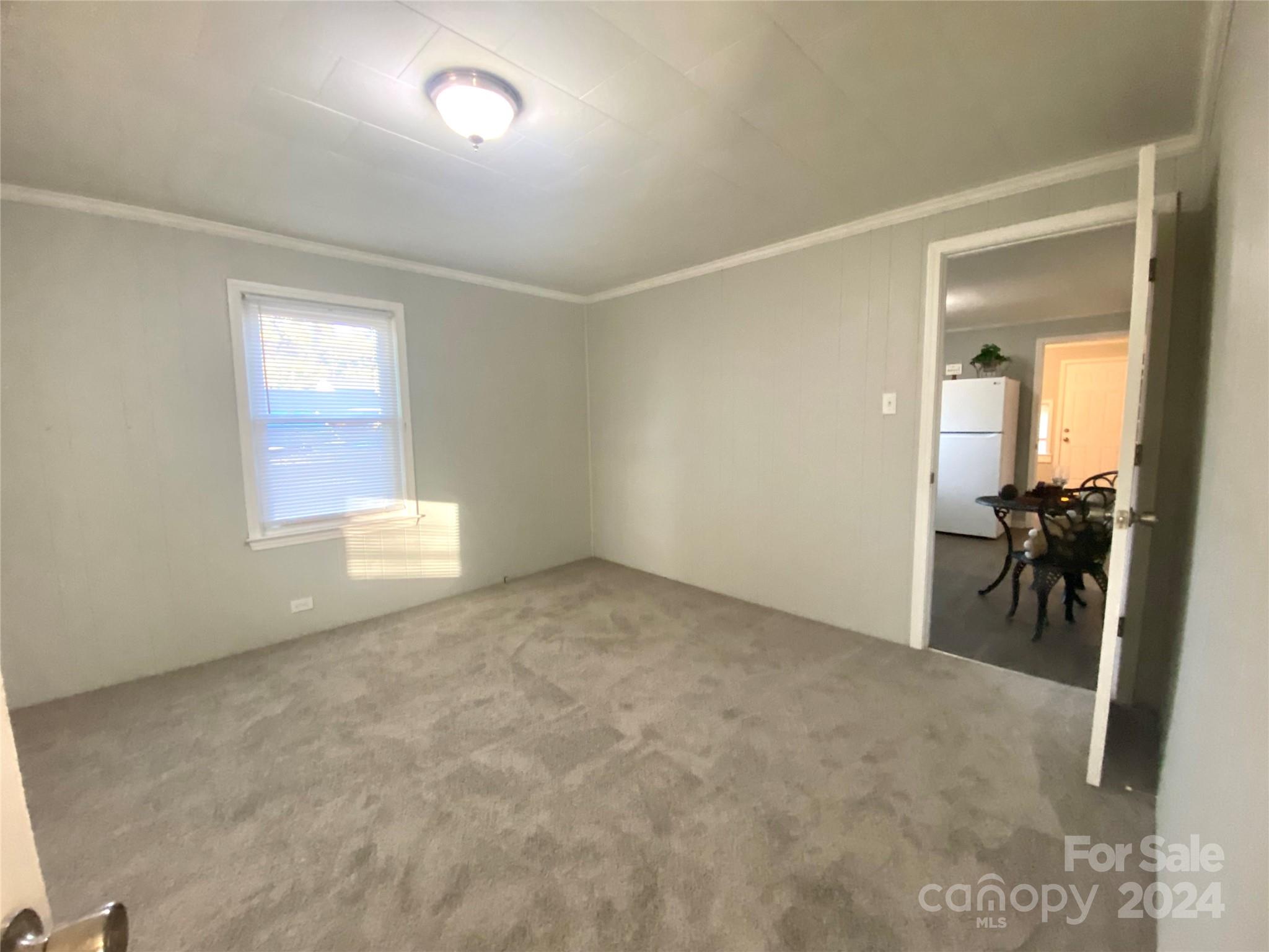417 East Rice Street Landis, NC 28088 - Photo 7 of 22 an empty room with furniture and a window