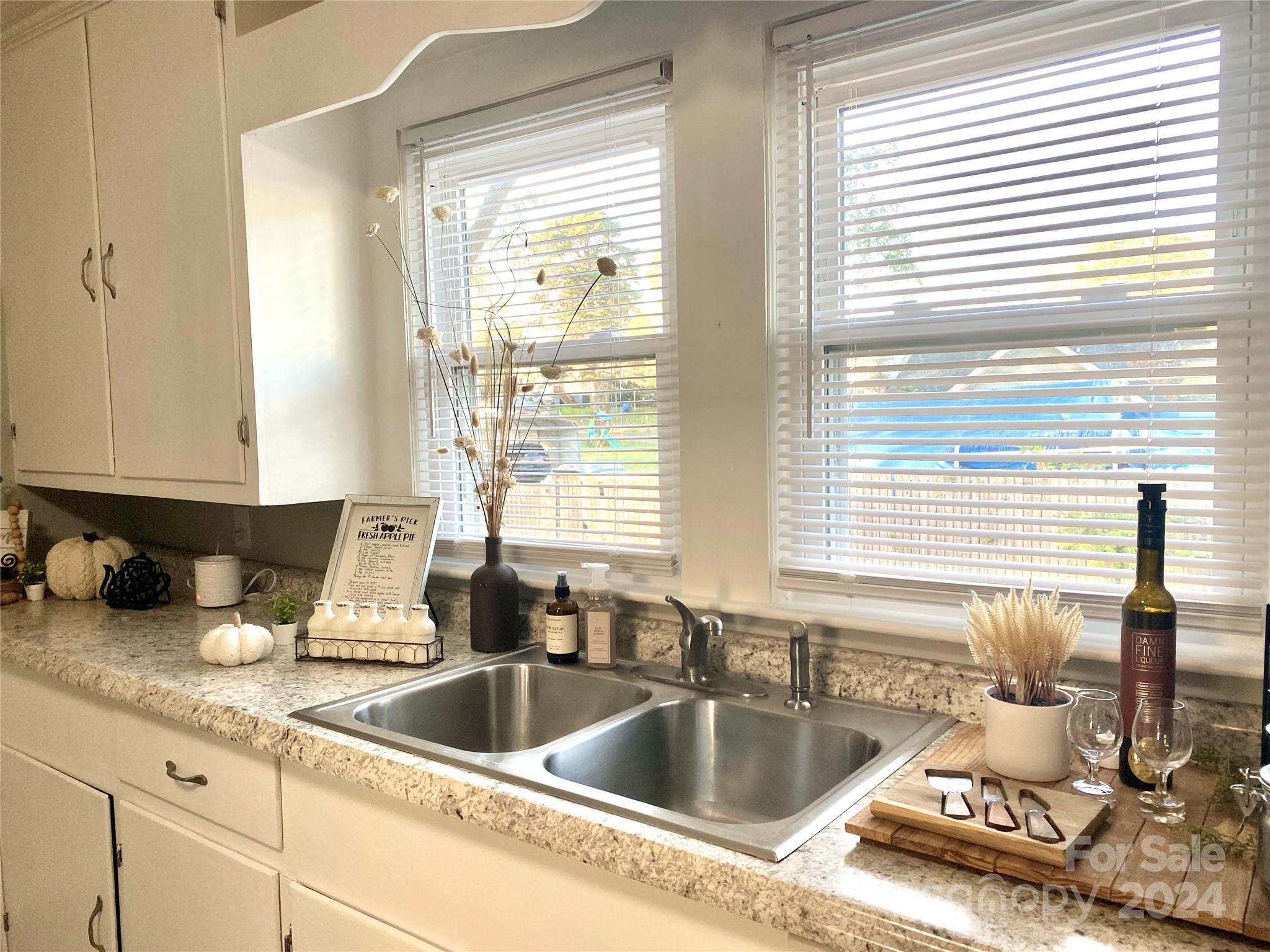 417 East Rice Street Landis, NC 28088 - Photo 9 of 22 a kitchen counter top space with granite countertop a sink and a window