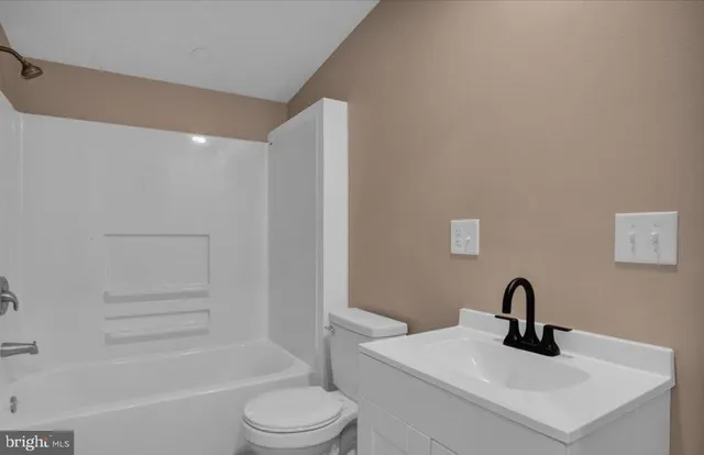 a bathroom with a sink a toilet and a bathtub