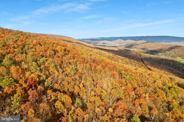 a view of a house with yard and sitting area