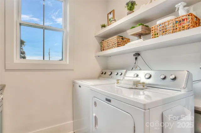 a kitchen with white cabinets and a sink