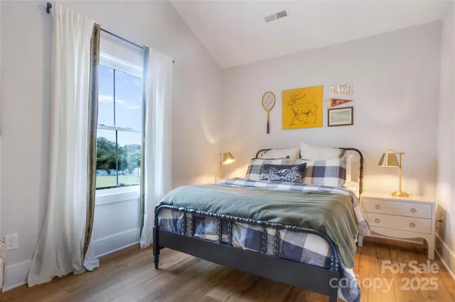 a bedroom with a bed and a tv on the dresser