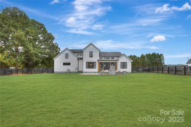a view of house with yard and green space